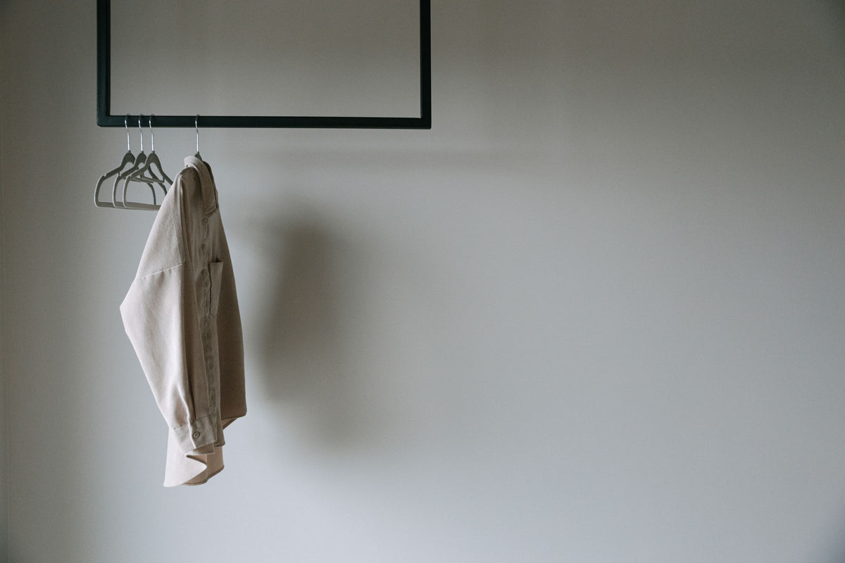 Minimal neutral shirt on a clothing rack